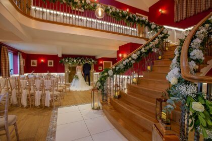 Couple standing in hall arranged for ceremony