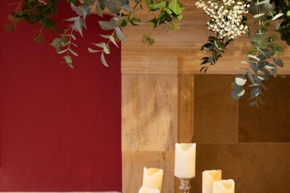 Close up of candelabra and flower garland on fireplace
