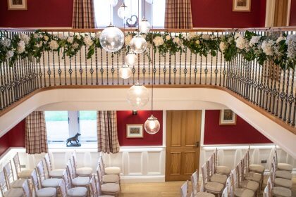 Hall arranged with chairs for ceremony seen from staircase