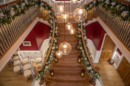 Flowers decorating staircase and landing, viewed from above