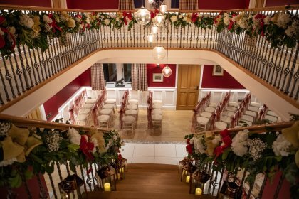 Hall with chairs arranged for ceremony viewed from stairs
