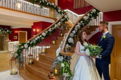 Couple standing in hall arrangement for ceremony