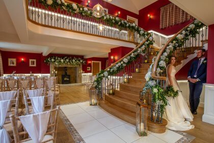 Couple standing in hall arrangement for ceremony